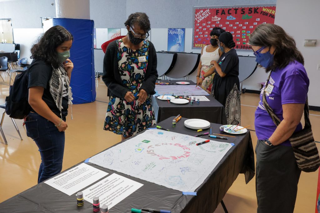 (L-R) Camp Participant Siani Colon, People's Bazaar vendor Dio Roberson, and CAB member Clemencia Rodriguez gazing upon the...